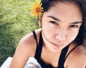 Close-up portrait of teenage girl wearing flower