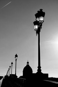 Low angle view of silhouette street light against sky