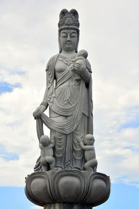 Low angle view of statue against sky