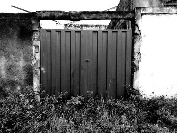 Close-up of wooden door against sky