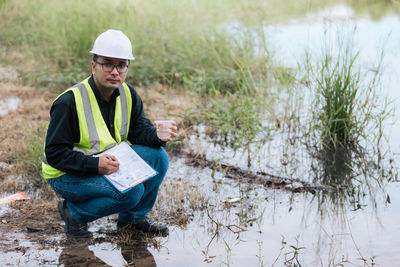 Full length of man standing on puddle