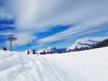 Scenic view of snow covered mountains against sky