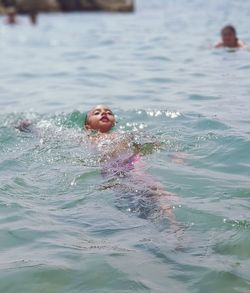 Portrait of boy swimming in pool