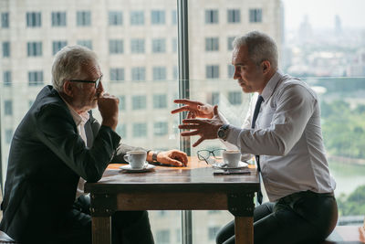 Man and woman sitting on table