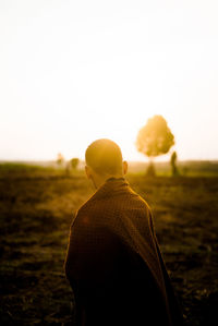 Rear view of man looking at field