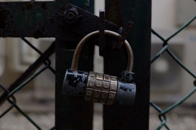 Close-up of padlock on chainlink fence