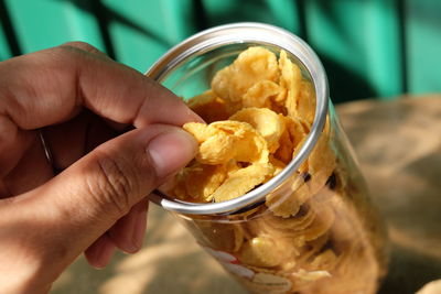 Close-up of hand holding chips