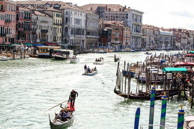 Boats in canal along buildings