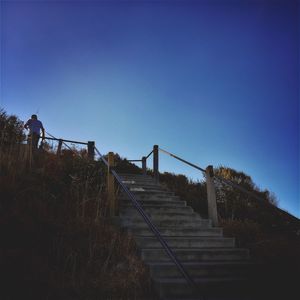 Low angle view of steps against clear blue sky