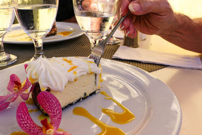 Hand holding ice cream cone on table