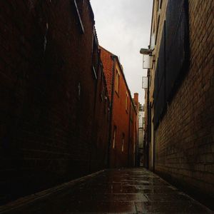 Empty road along buildings