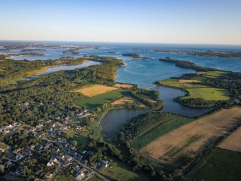 High angle view of land and sea against sky