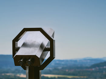 Close-up of coin-operated binoculars against clear sky