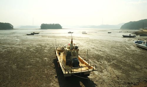 Ship moored on sea against clear sky