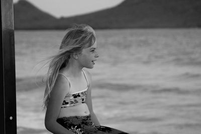 Happy girl looking at sea