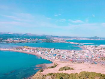 High angle view of sea and city against sky