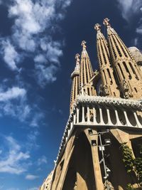Low angle view of building against cloudy sky