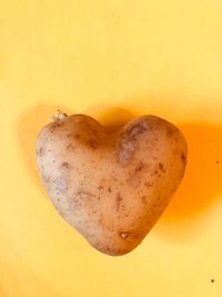 Close-up of heart shape against yellow background