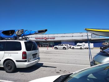 Cars on road against blue sky