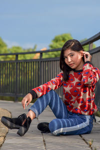 Portrait of young woman sitting on chair
