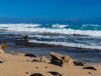 Scenic view of sea against blue sky