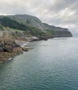 Scenic view of sea and mountains against sky