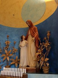 Low angle view of angel statue against wall