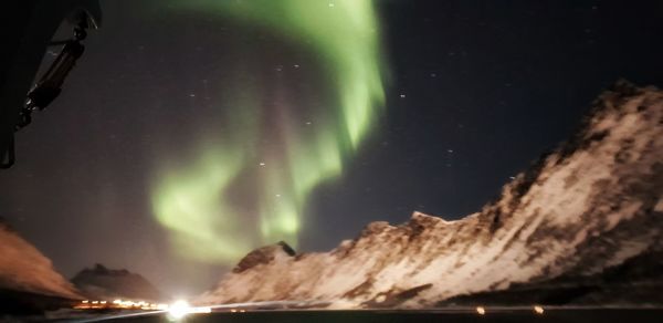 Low angle view of illuminated mountain against sky at night