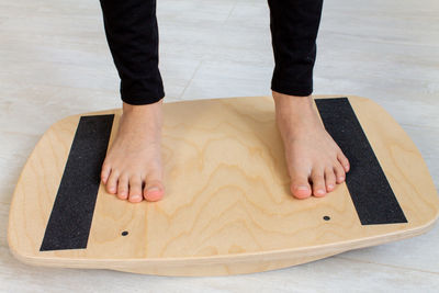 Low section of woman on balance board