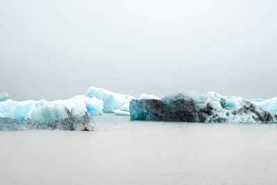 Scenic view of frozen lake against sky during winter