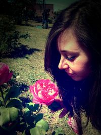 Portrait of woman holding pink flower