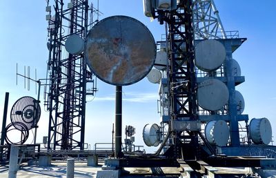 Low angle view of communications tower against sky