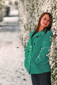 Portrait of woman standing in snow