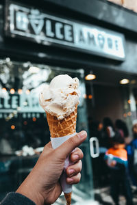 Hand holding ice cream cone