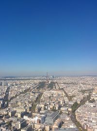 Aerial view of city against blue sky