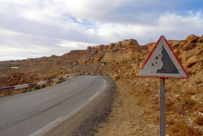 Road sign against mountain