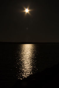 Scenic view of sea against sky at night