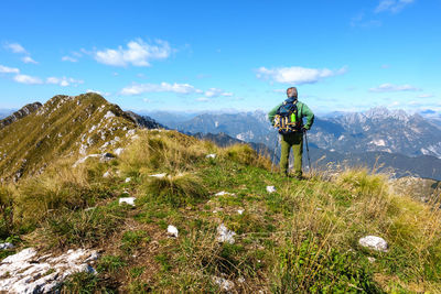 Man standing on mountain against sky