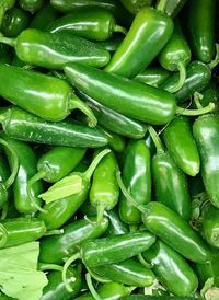 Full frame shot of green chili peppers at market stall