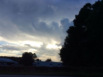 Silhouette trees against sky at dusk