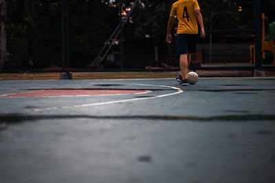 Low section of man playing soccer