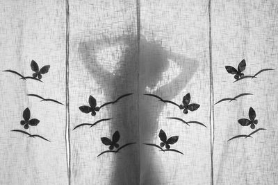 Shadow of woman on curtain