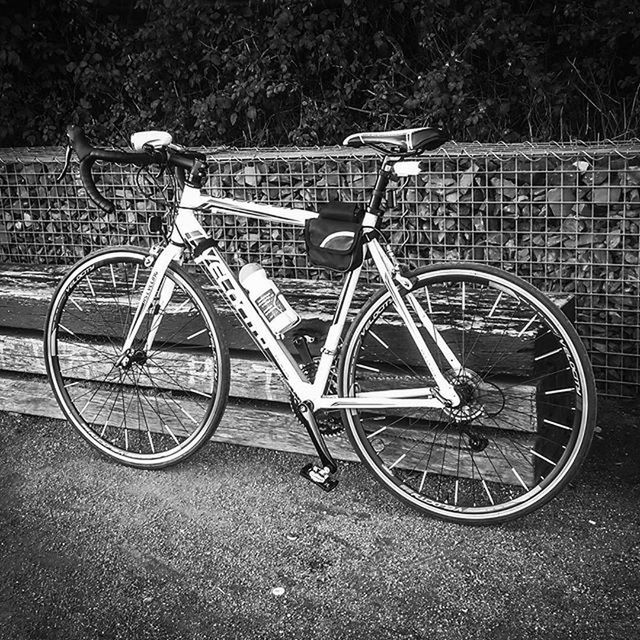 bicycle, transportation, mode of transport, land vehicle, stationary, parked, parking, wheel, leaning, street, outdoors, no people, day, cycle, tire, absence, travel, cart, sunlight, side view