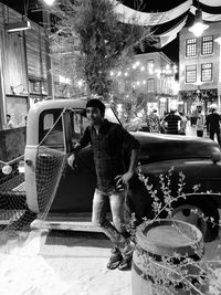 Full length portrait of man standing on street in city