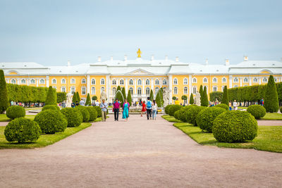 People walk on path way to the peterhof palace.