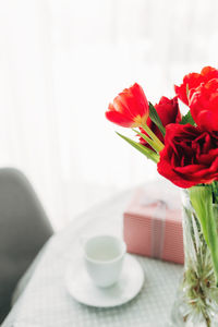 Close-up of red roses in vase on table