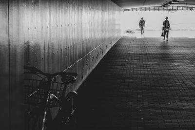 Rear view of people walking on footpath