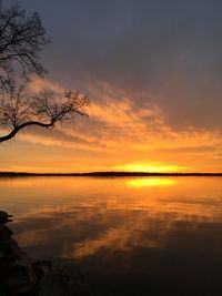 Scenic view of lake against romantic sky at sunset