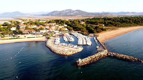 High angle view of sea by mountain against sky