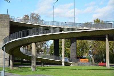 Low angle view of bridge over grassy field
